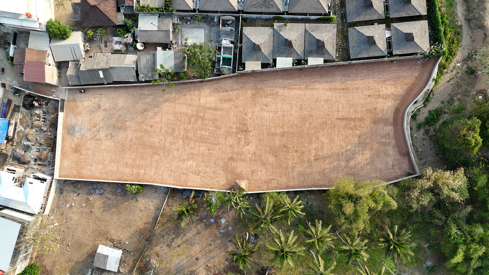 Top-down drone photograph of the walled, cleared parcel